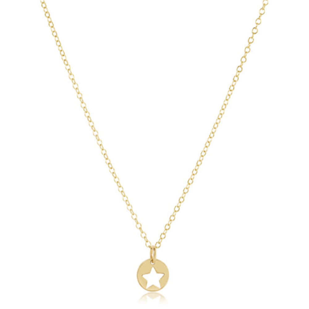A delicate gold chain necklace featuring a small circular pendant with a cutout star in the center, displayed against a solid white background.