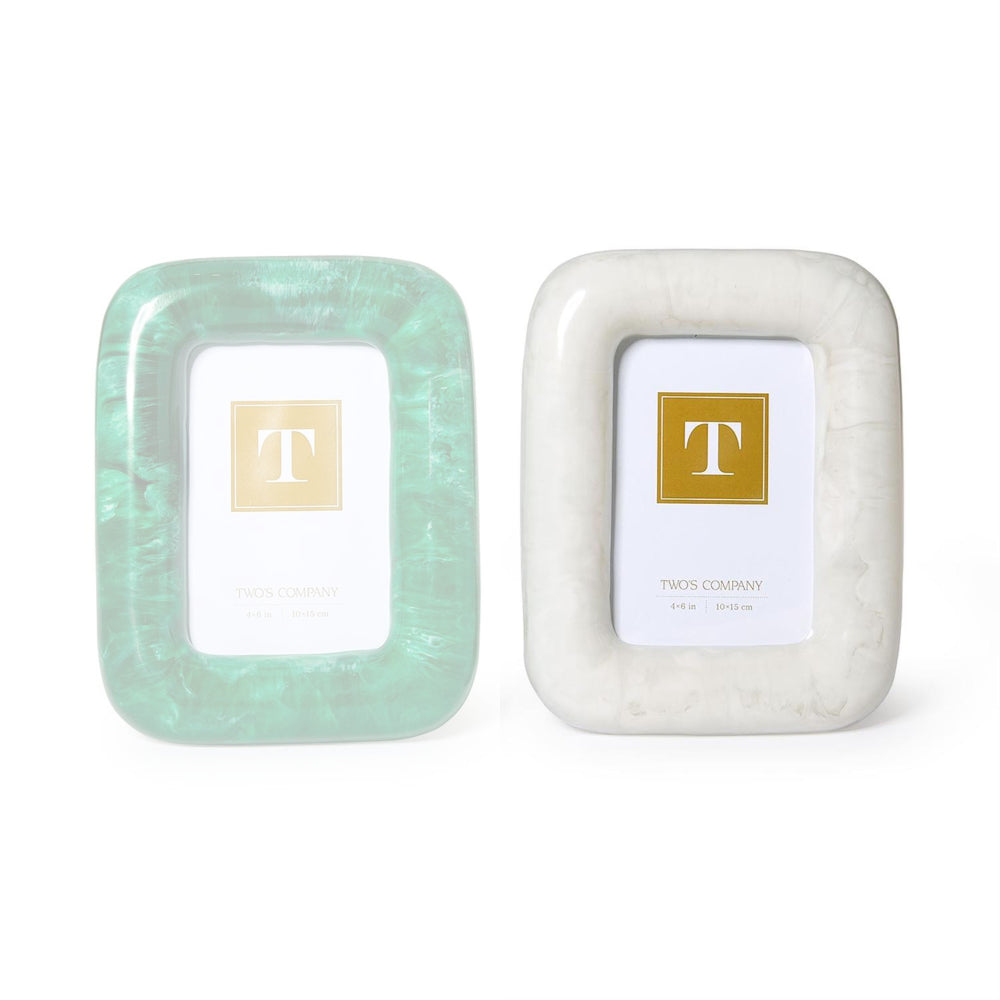 Two small square picture frames by Twos Company on a white background. The left frame has a mint green marbled border, and the right frame has a white marbled border.