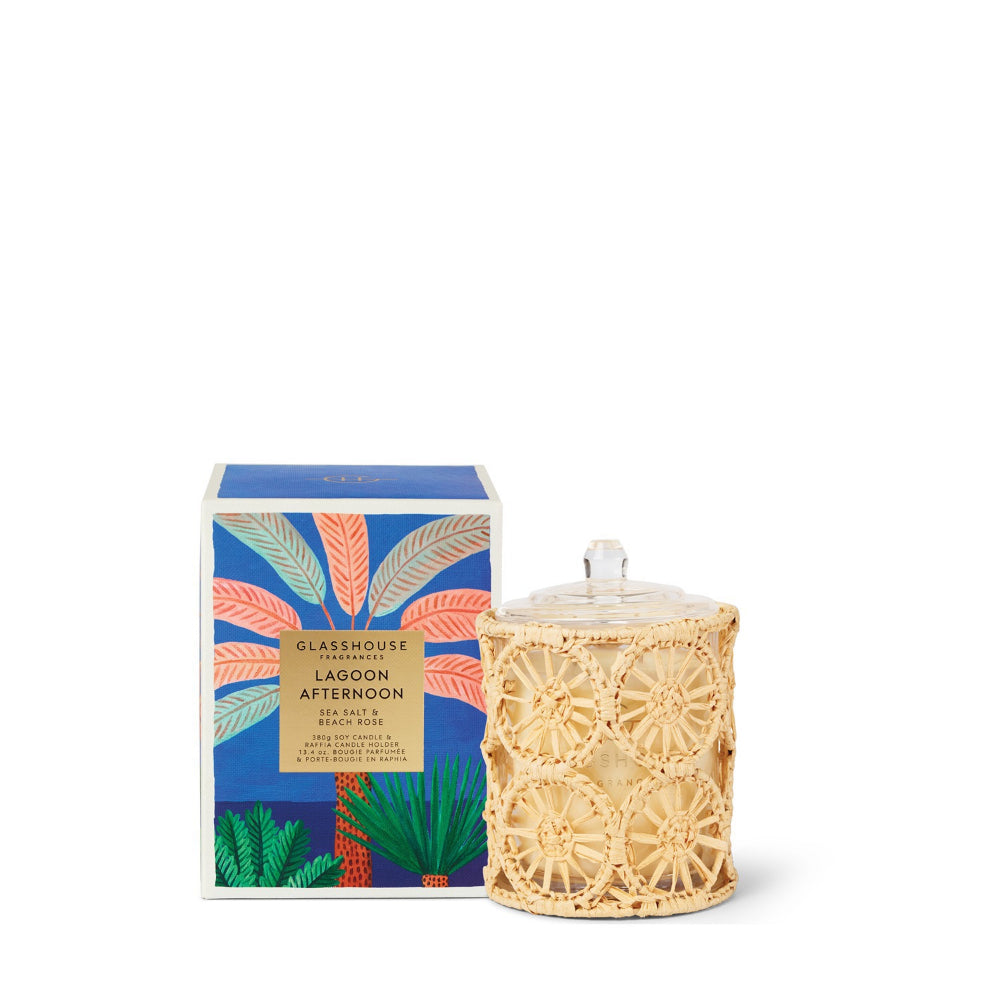 Candle with decorative wicker lid and colorful packaging on a white background