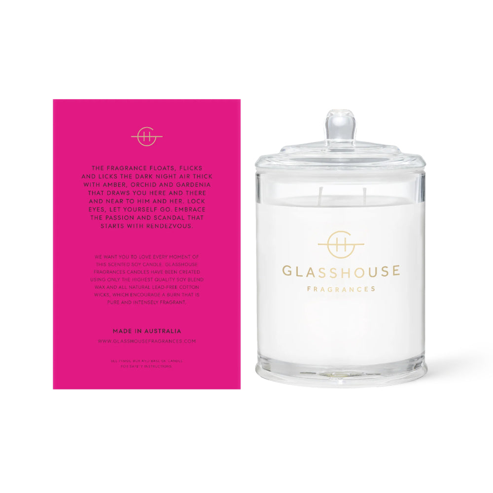 The back of a glasshouse Fragrances pink packaging and text with clear candle "Rendezvous" on a white background.