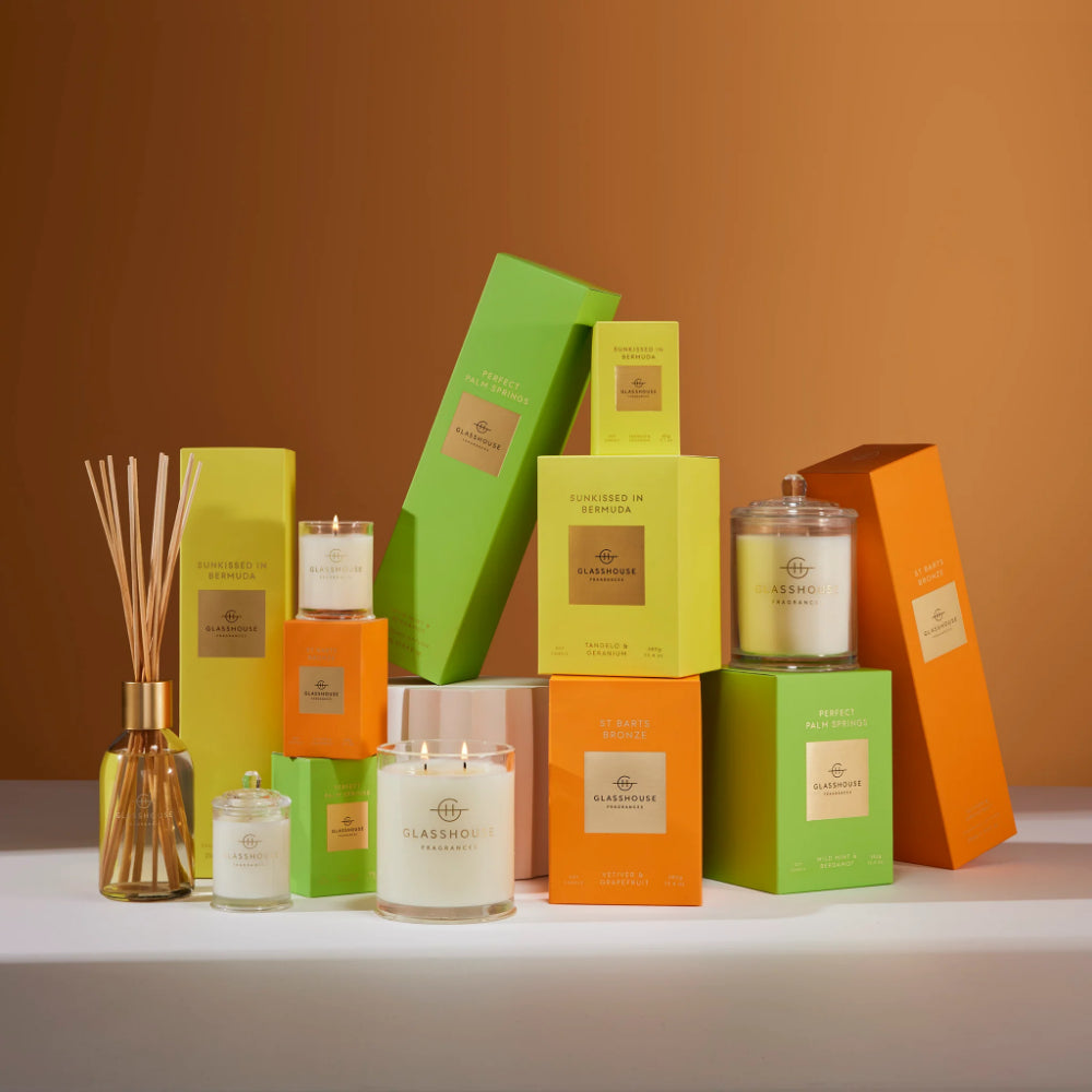 Assorted candles and packaging on a neutral background