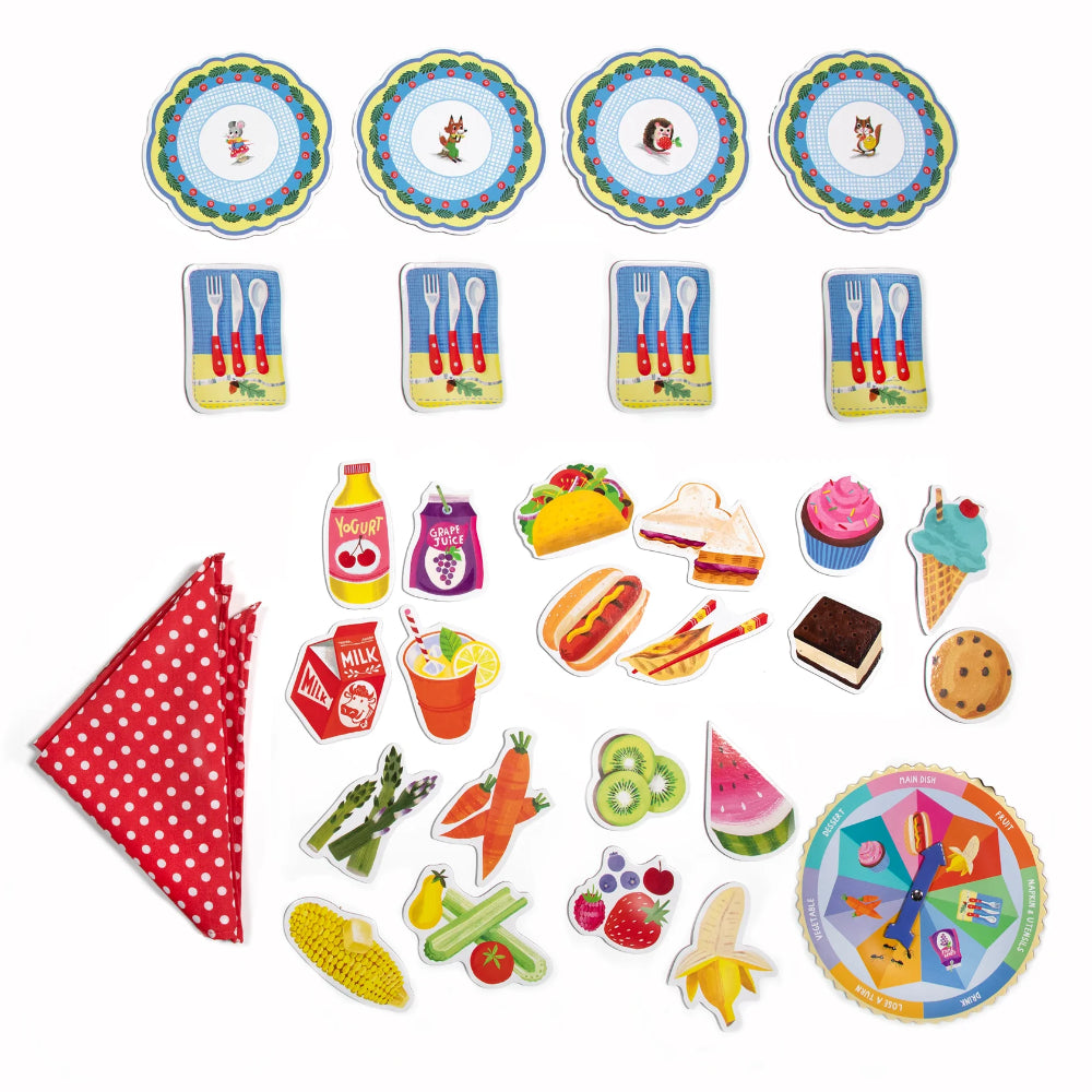 Colorful food-themed game pieces and a red polka dot napkin on a white background