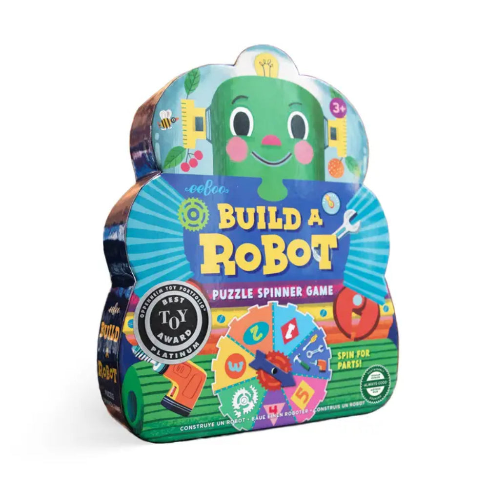 Coolor Build a Robot Puzzle Spinner Game in a robot-shaped metal tin with colorful illustrated graphics and game pieces visible through the front window, on a white background.