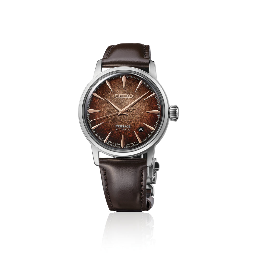 A Seiko wristwatch with a brown textured dial, rose gold-tone indices and hands, and a dark brown leather strap, shown against a plain white background.