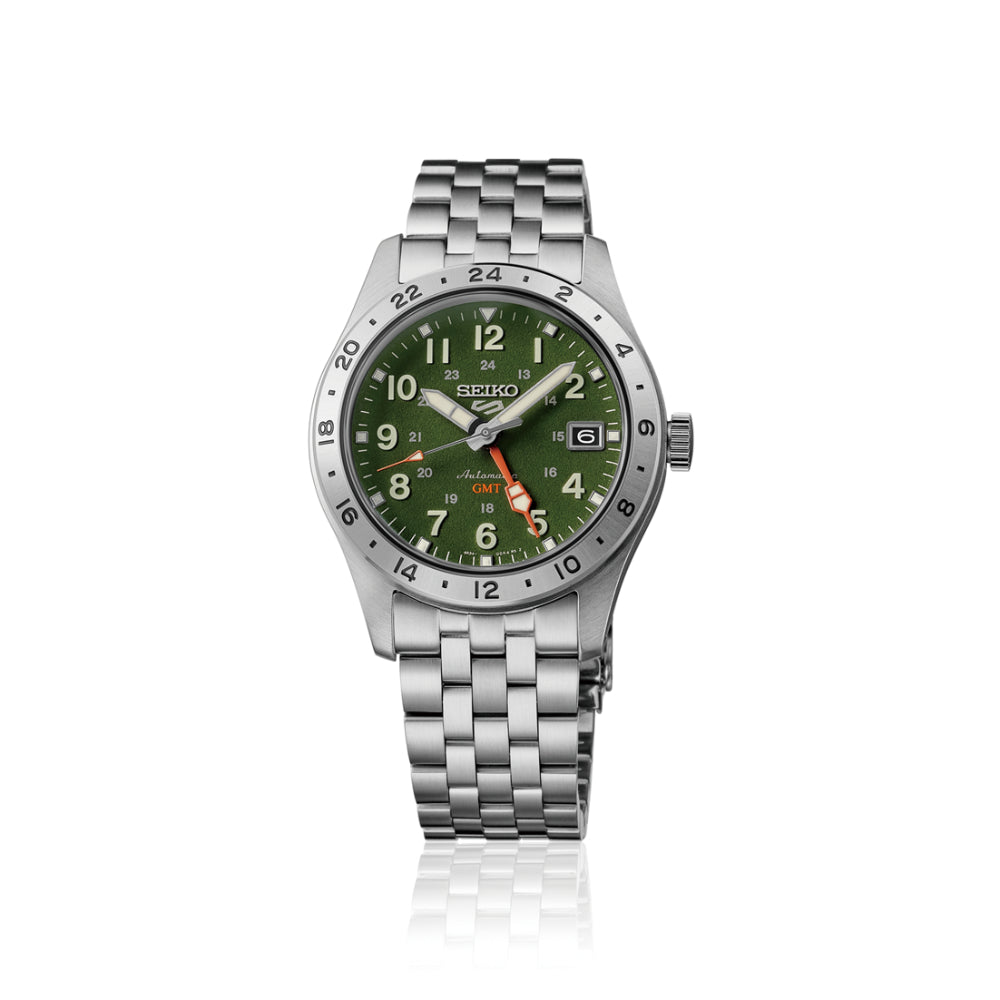 A Seiko wristwatch with a silver stainless steel link bracelet, a silver bezel, and a green dial featuring white Arabic numerals and a date window.