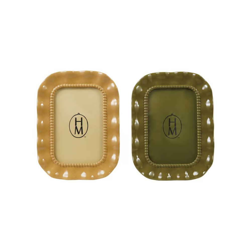 Two decorative rectangular 4x6 frames with scalloped edges and a central monogram logo, shown side by side on a white background. One tray is warm beige with a gold-toned border, and the other is olive green with a dark olive border.