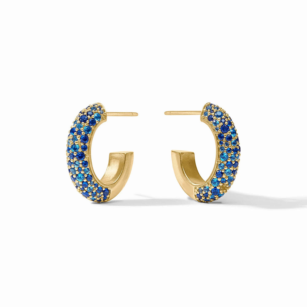Gold hoop earrings with blue gemstones on a white background
