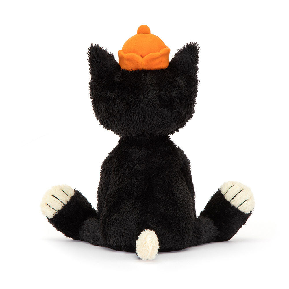 A photo of the side of a plush tuxedo cat with a black and white fur, orange stitched paws, and a velour crown.