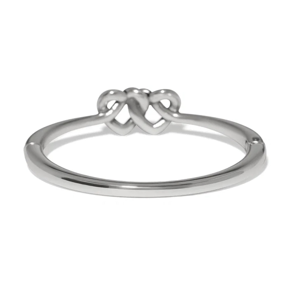 Silver bangle with a knot design on a white background