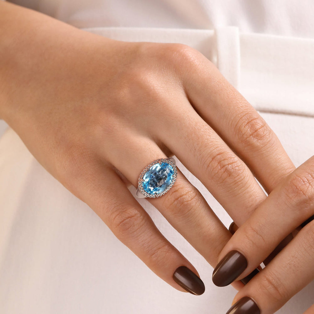 Close-up of a hand wearing a Signet Blue Topaz ring