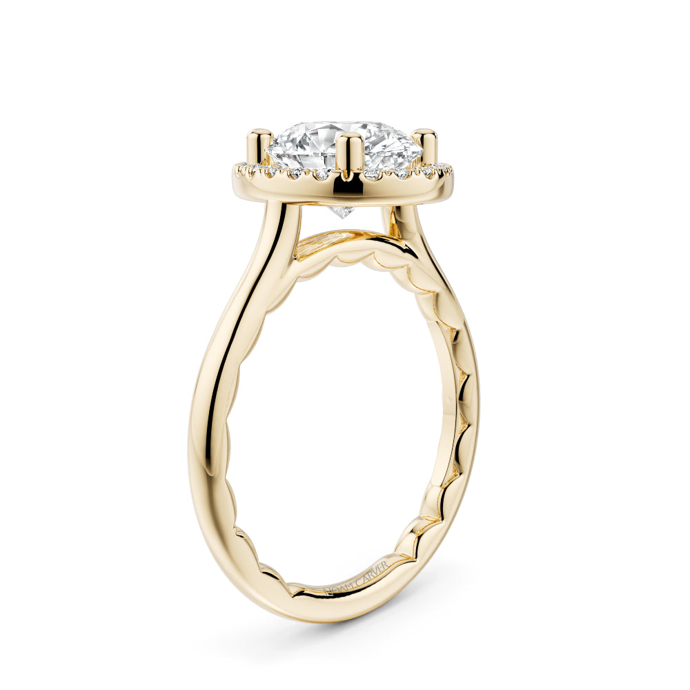 Gold Noam Carver ring with a large oval diamond center and smaller round diamond sides on a white background