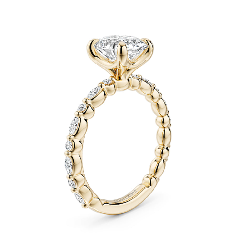 Gold Noam Carver ring with a large oval diamond center and smaller round/marquise diamond sides on a white background