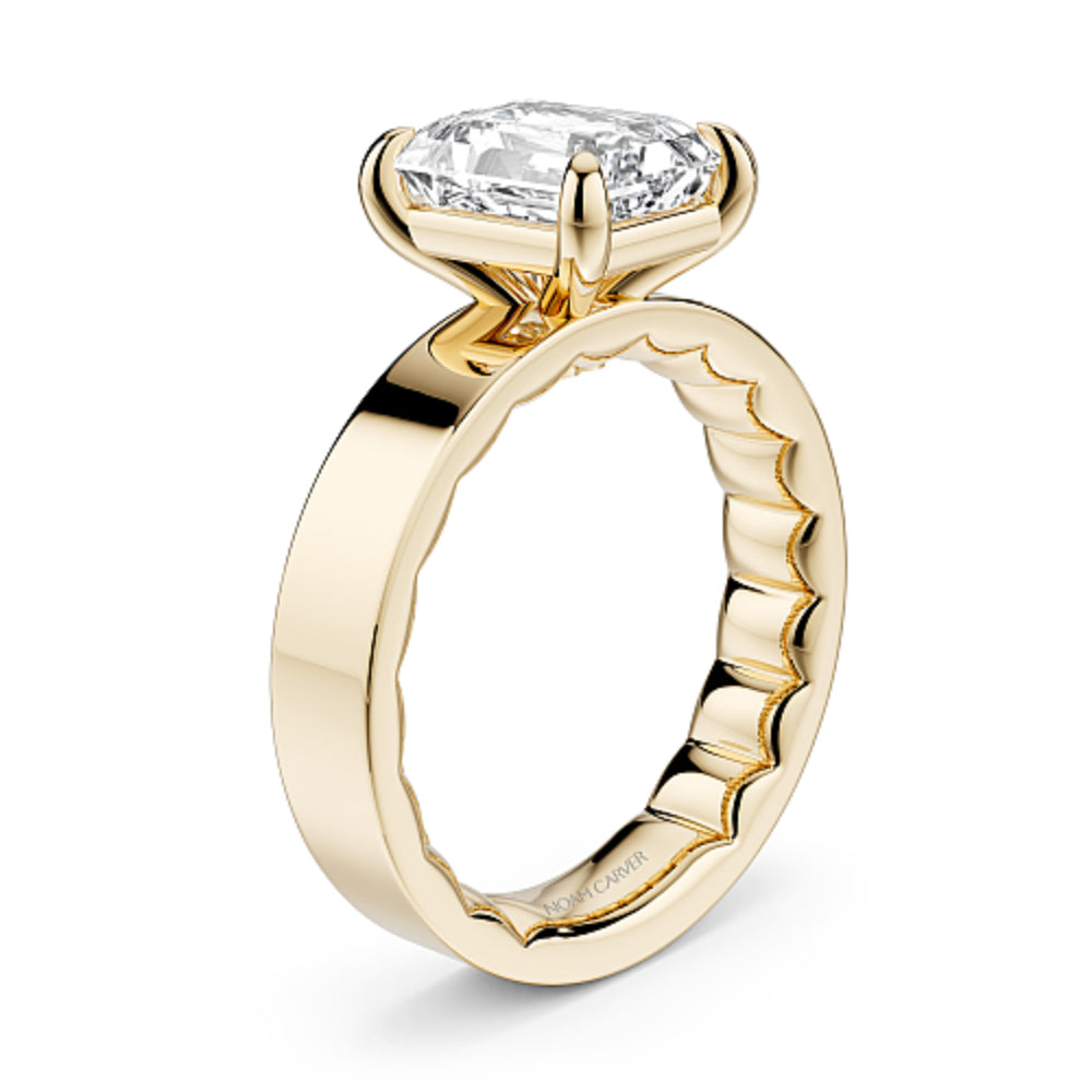Wide band gold ring with a large emerald cut diamond on a white background