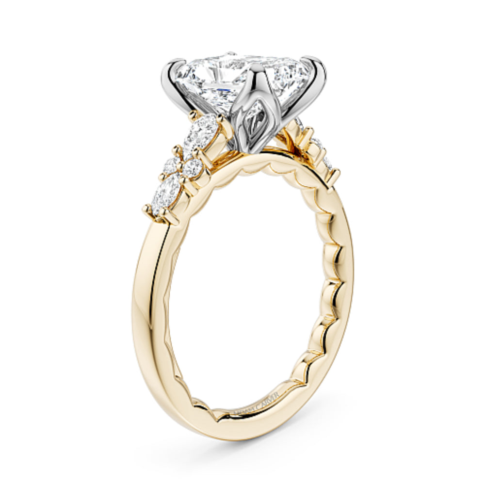 Gold and diamond Noam Carver ring with a radiant cut diamond center on a white background