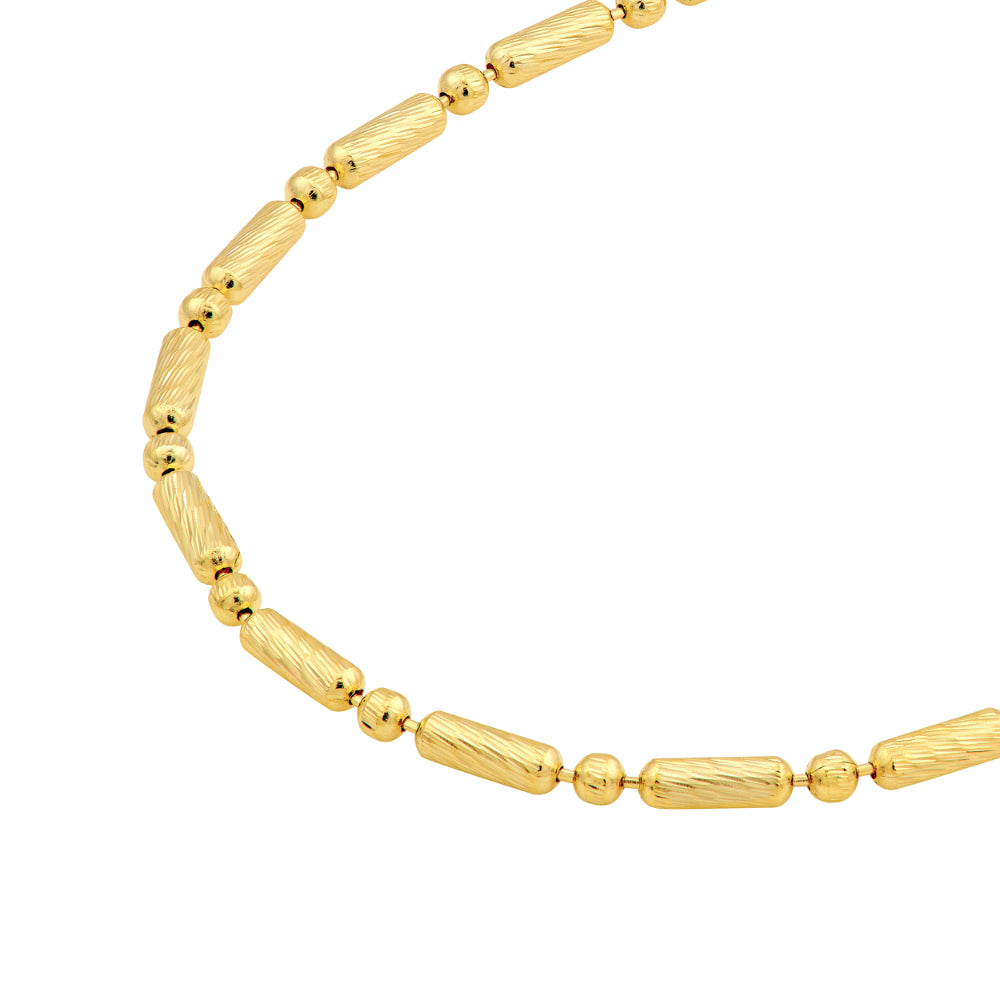 close-up of gold tone necklace on white background