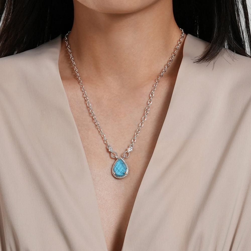 Close up of White sapphire and turquoise drop pendant necklace