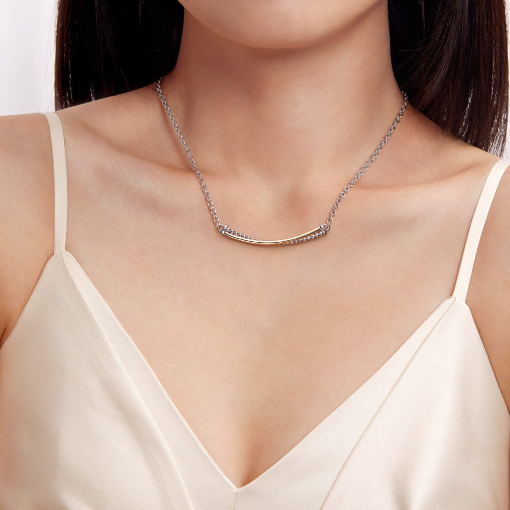 Woman wearing silver and gold bar necklace