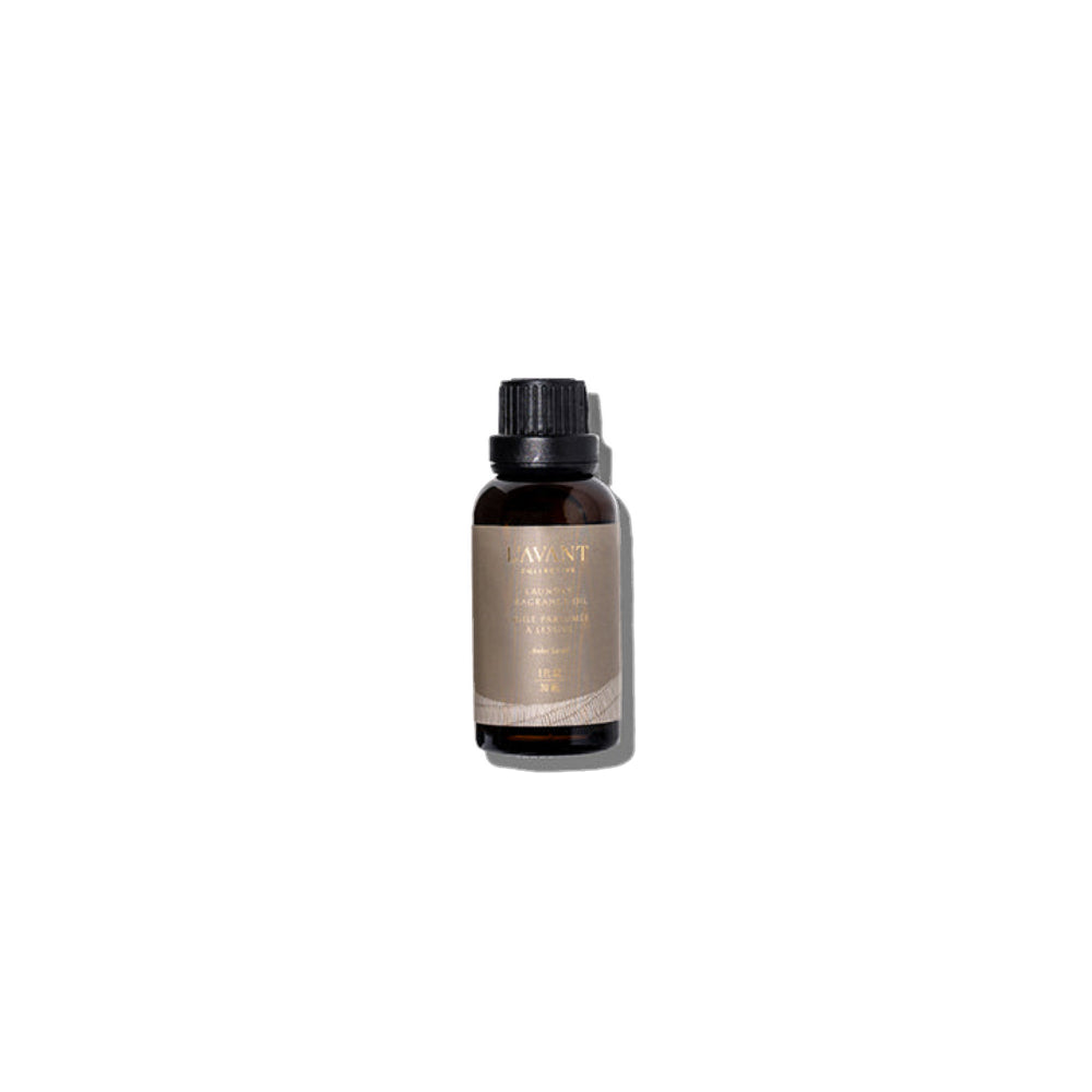 A small amber glass bottle with a black ribbed cap and a beige label reading 'LAWNT' and 'SILK CLOVER OIL', centered on a plain white background.