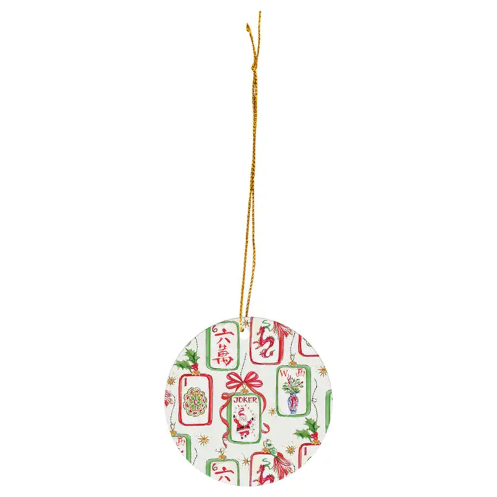 A round hanging ornament featuring a festive mahjong tile pattern in red, green, and gold on a white background, suspended by a gold string.