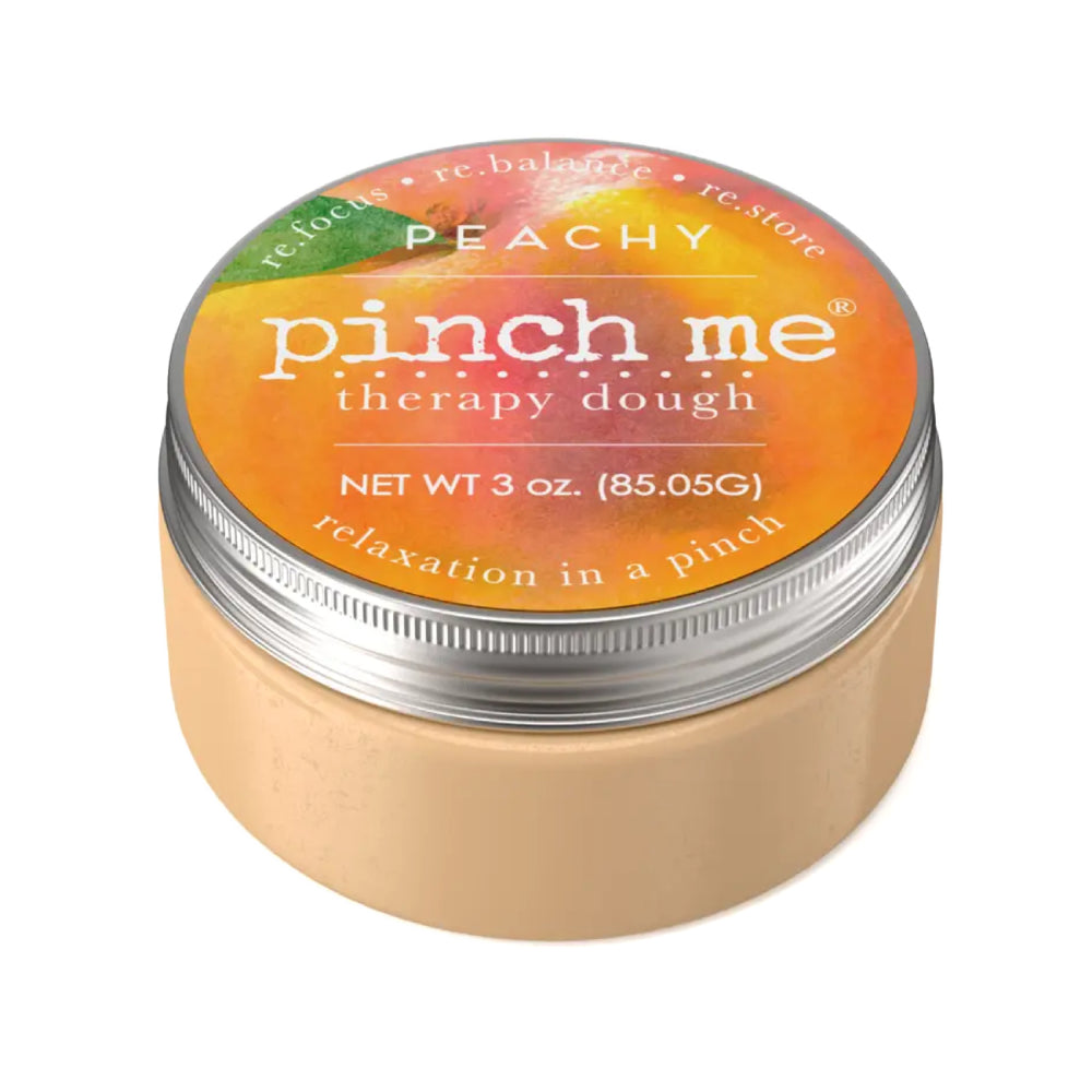 Jar of 'pinch me' therapy dough with peach scented on a white background.