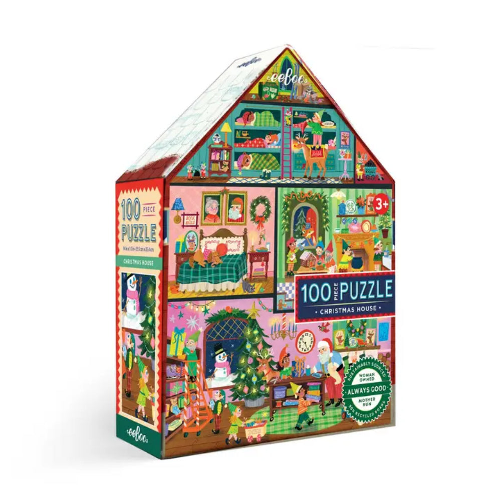 A 100-piece jigsaw puzzle box shaped like a house, featuring a colorful Christmas house illustration with festive interior scenes, the text '100 PUZZLE', 'Christmas House', and a green 'Always Cool' badge, shown on a white background.