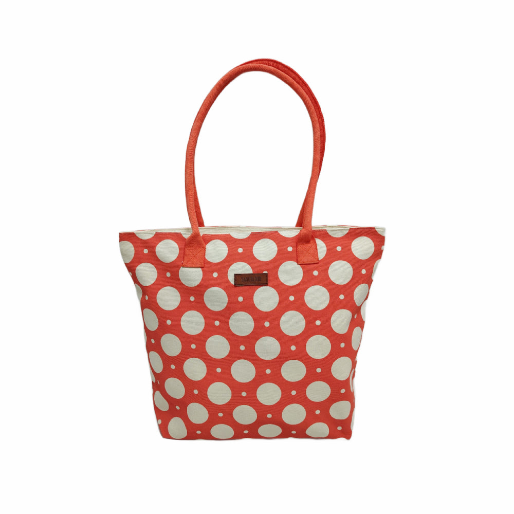 Red tote bag with white polka dots on a white background