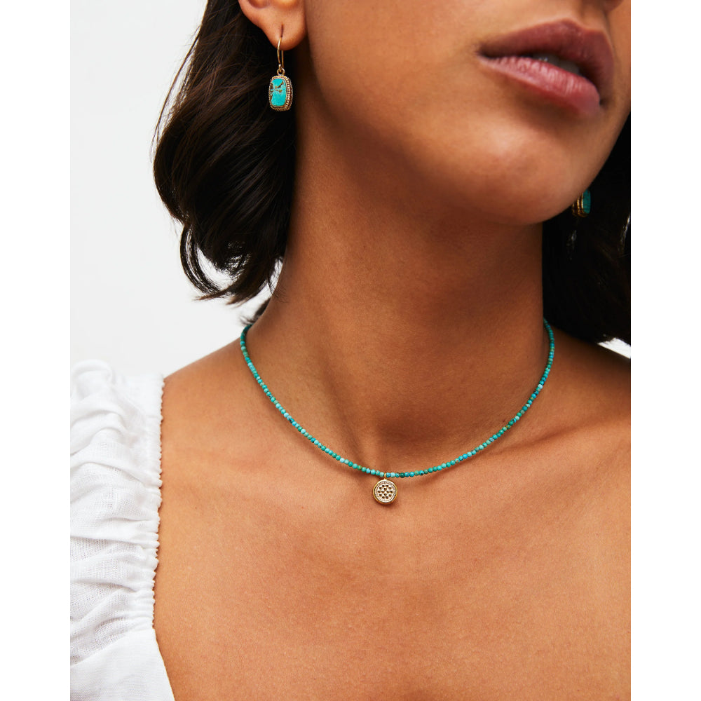 woman wearing greenish blue beaded necklace