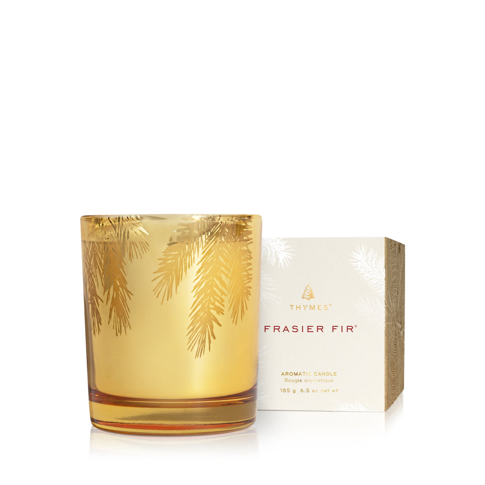 Thymes Frasier Fir candle with gold leaf design on a white background