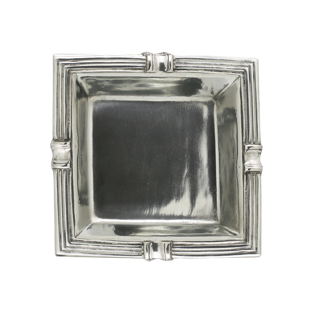 Silver decorative cigar ashtray with fancy edges on a white backround.
