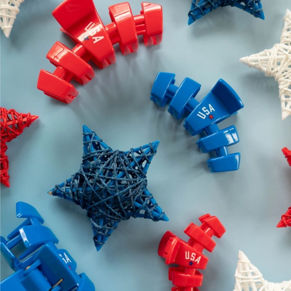 Red and blue plastic clips with 'USA' text on a light blue background