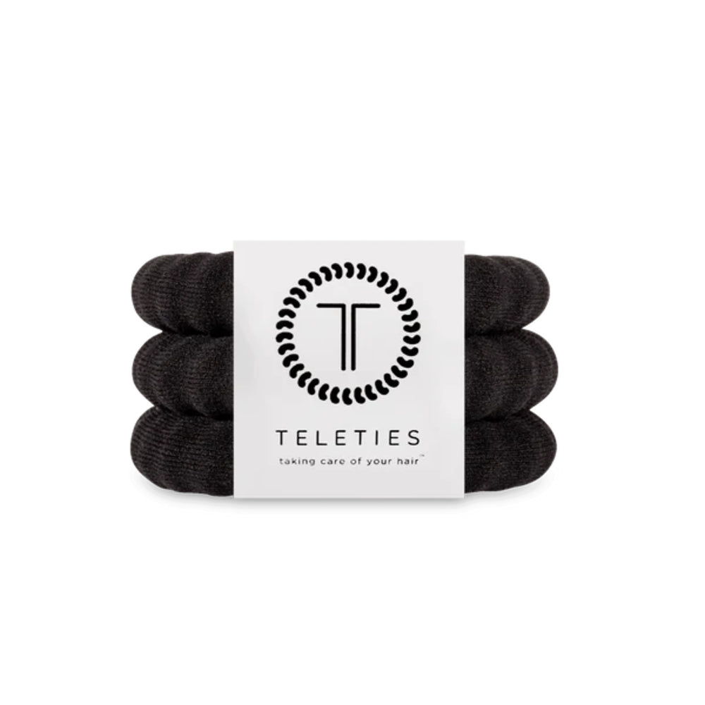Three black hair ties stacked on a white background with 'Teleties' branding.