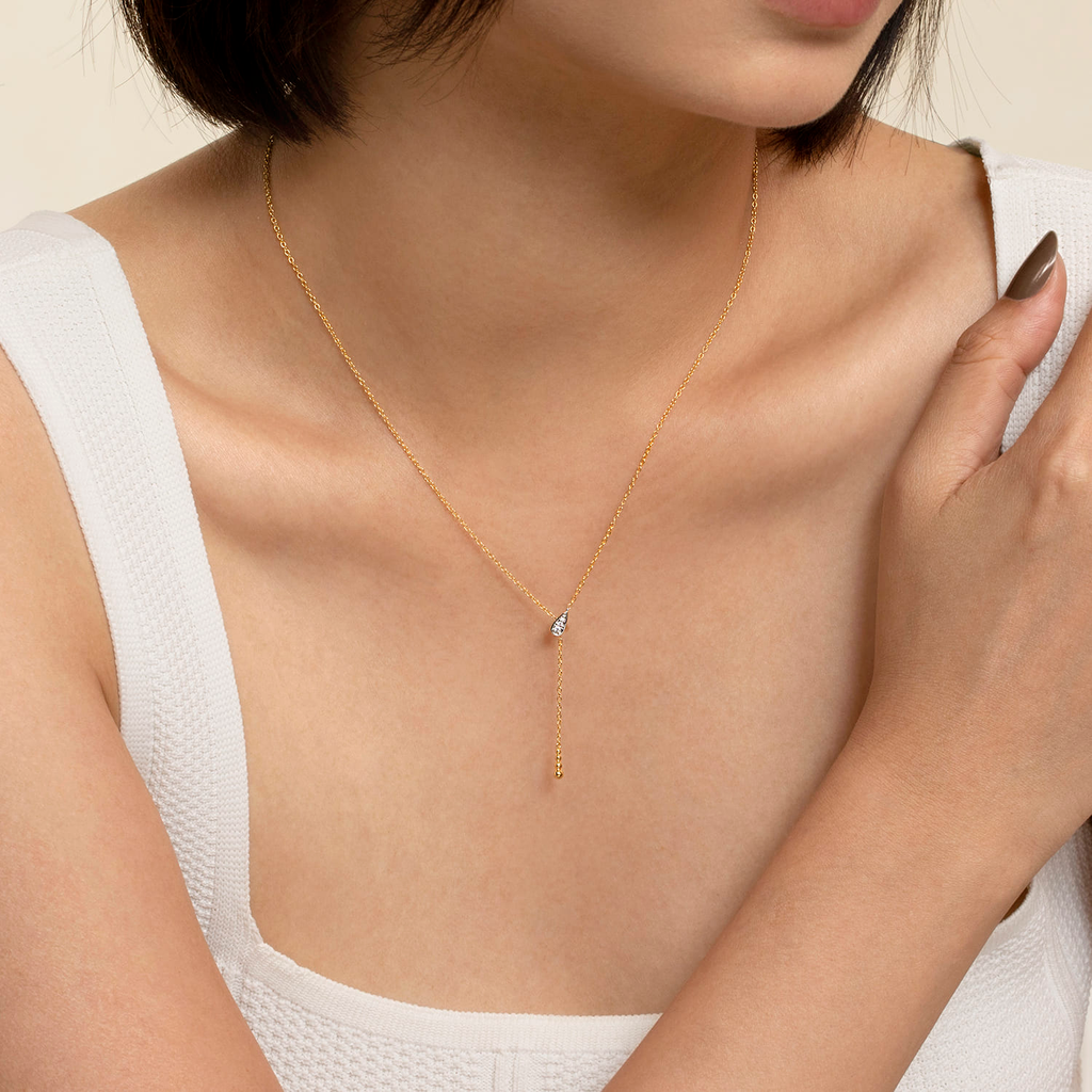 girl wearing yellow and white necklace on natural background