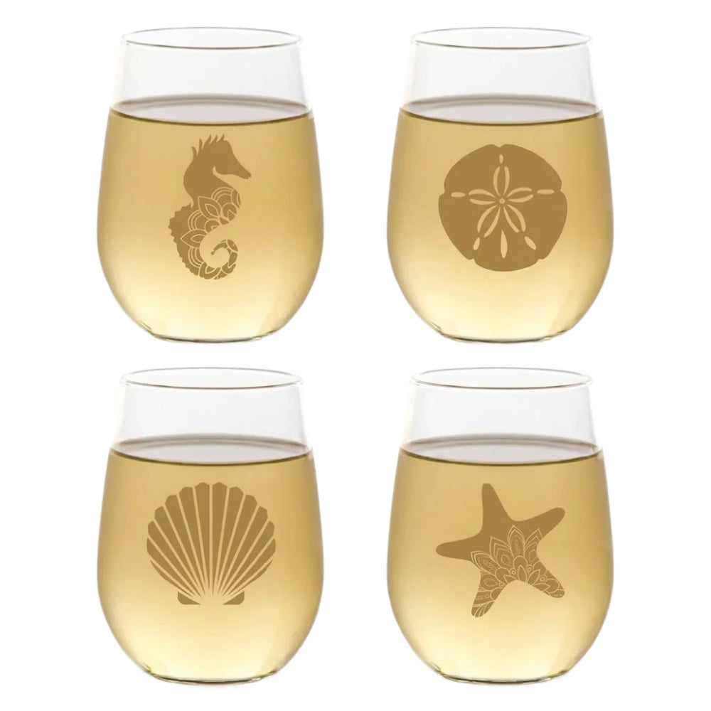Four stemless wine glasses with beach-themed etchings on a white background