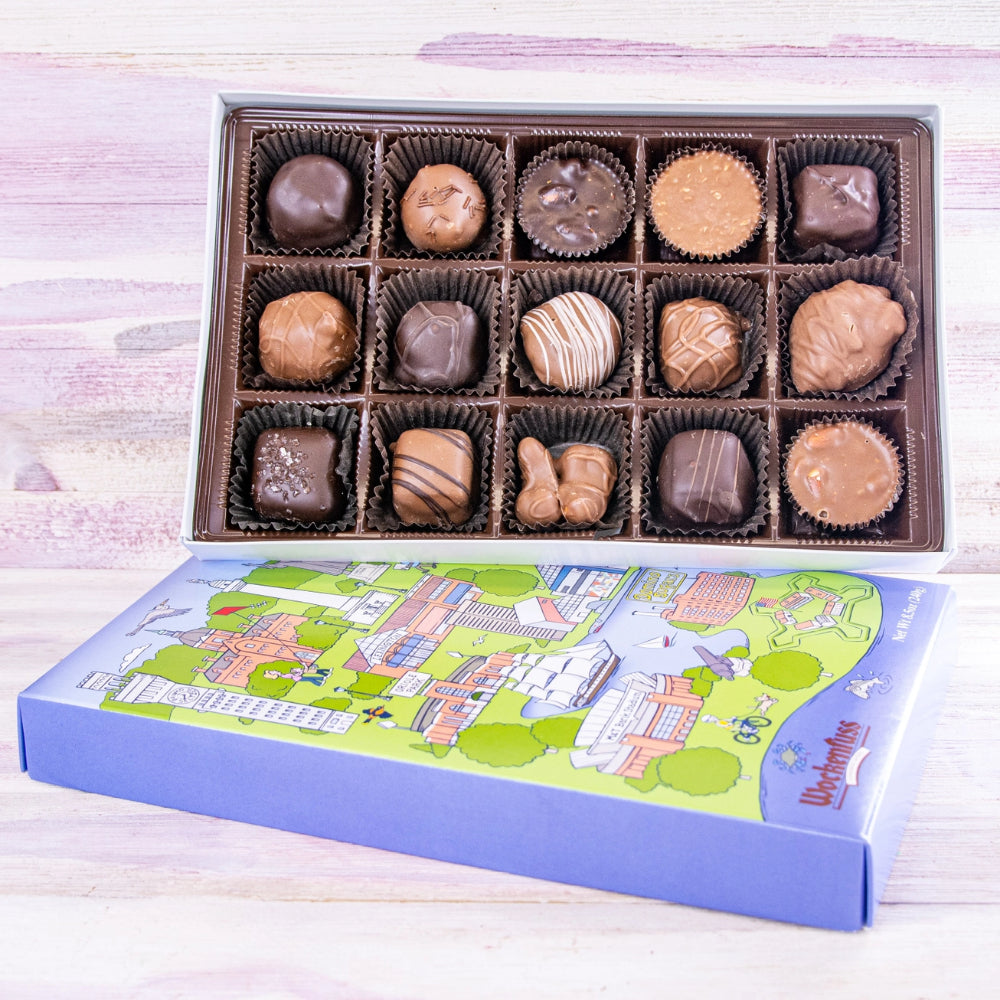 Open box of wochenfuss candy with a colorful illustration of a baltimore cityscapes on a white background.