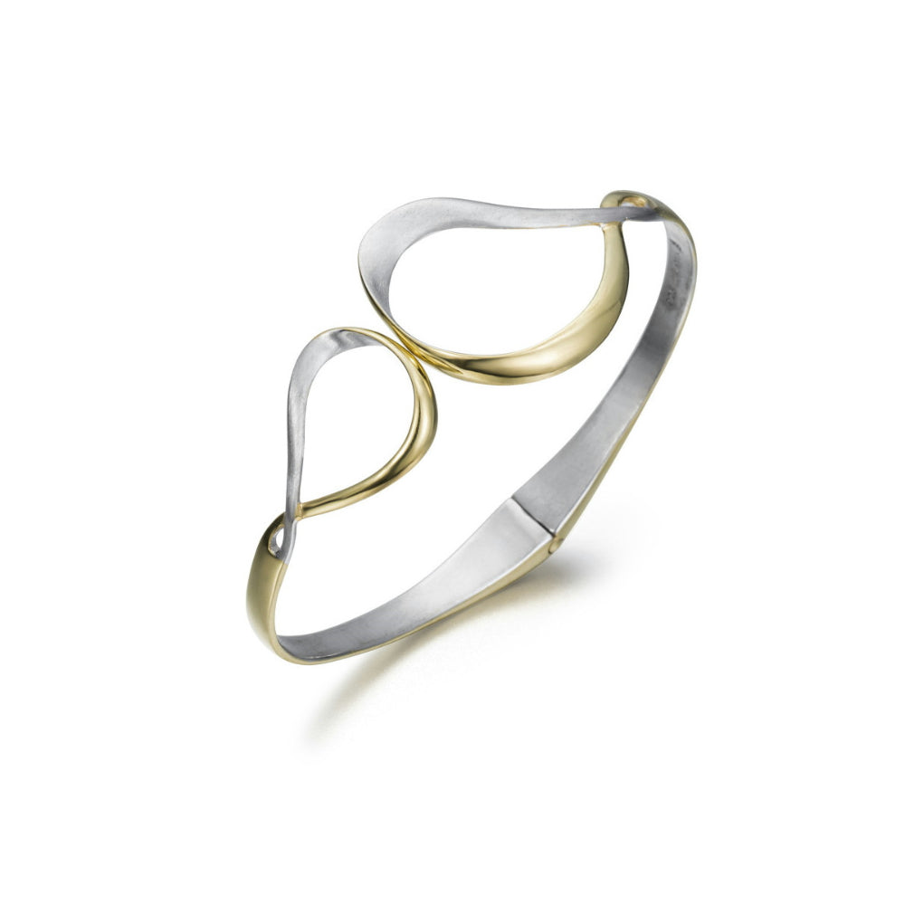 A two-tone metal bangle bracelet featuring a polished silver-toned band and gold-toned accents, shown on a clean white background.