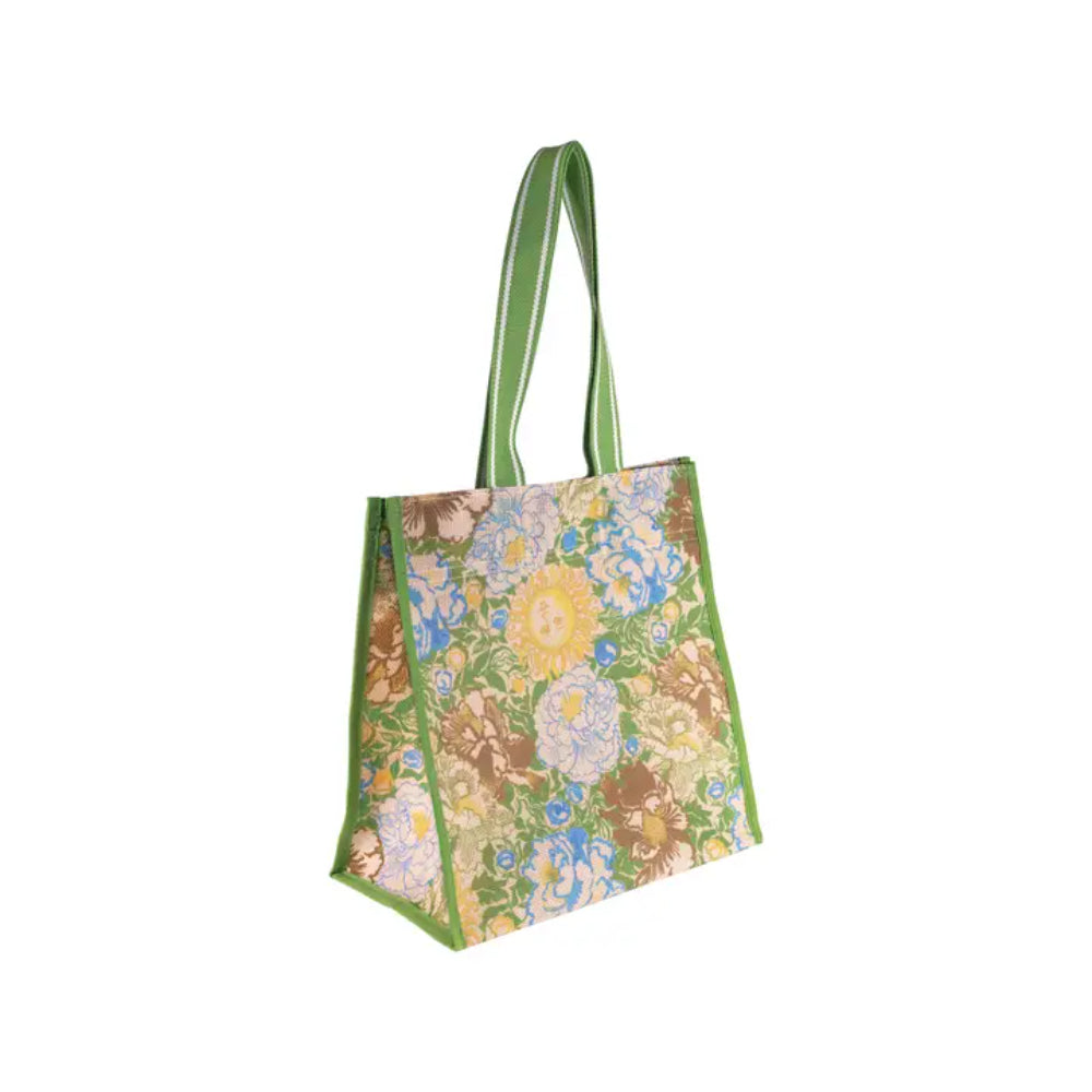 A canvas tote bag with a vibrant multicolor floral print and green handles, shown on a plain white background.