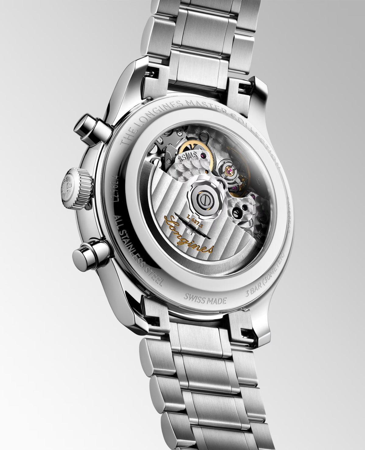 Close-up of the back of a stainless steel wristwatch with a transparent case back, showing the exposed mechanical movement and bracelet, on a light gray gradient background.