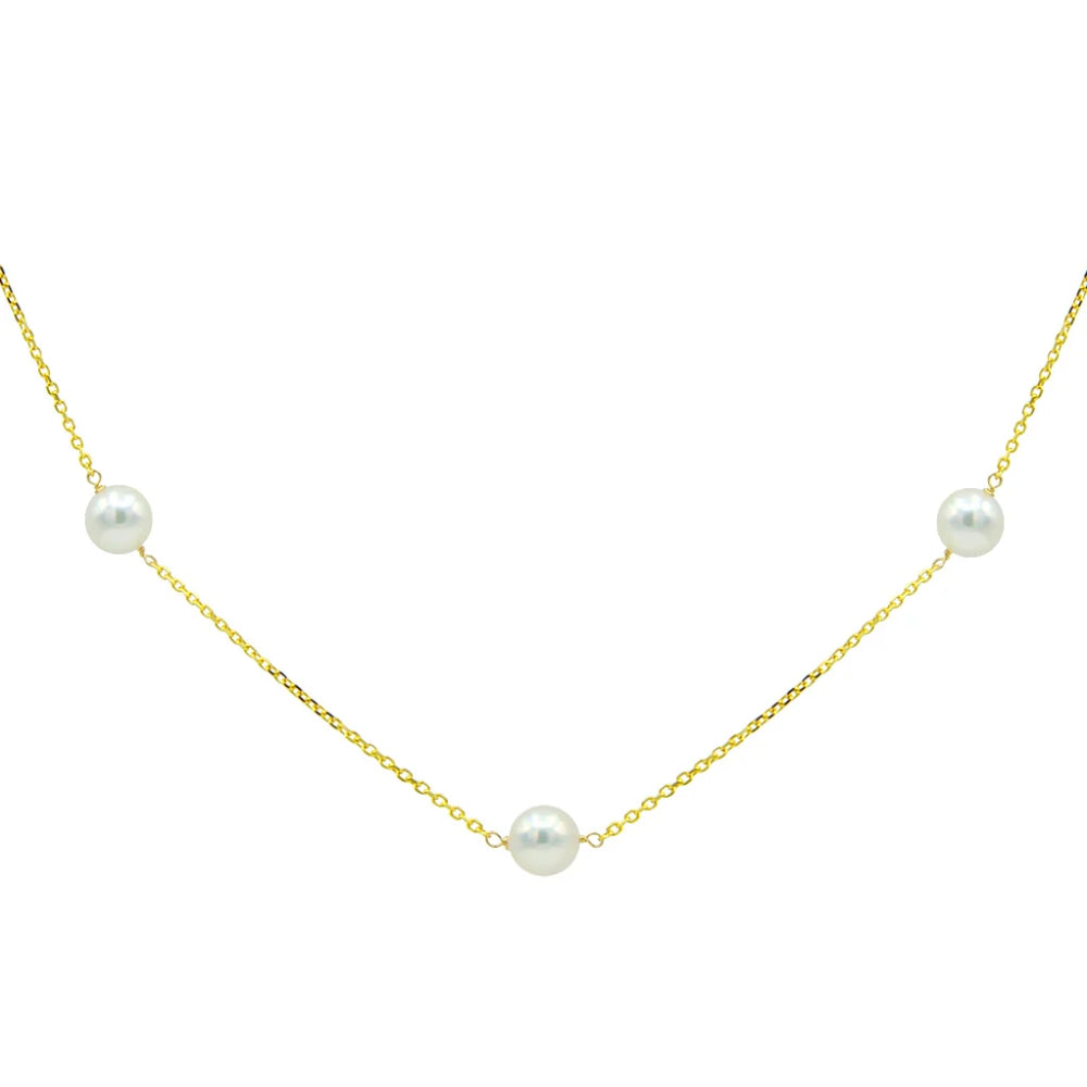 gold tone chain with white pearls on a white background