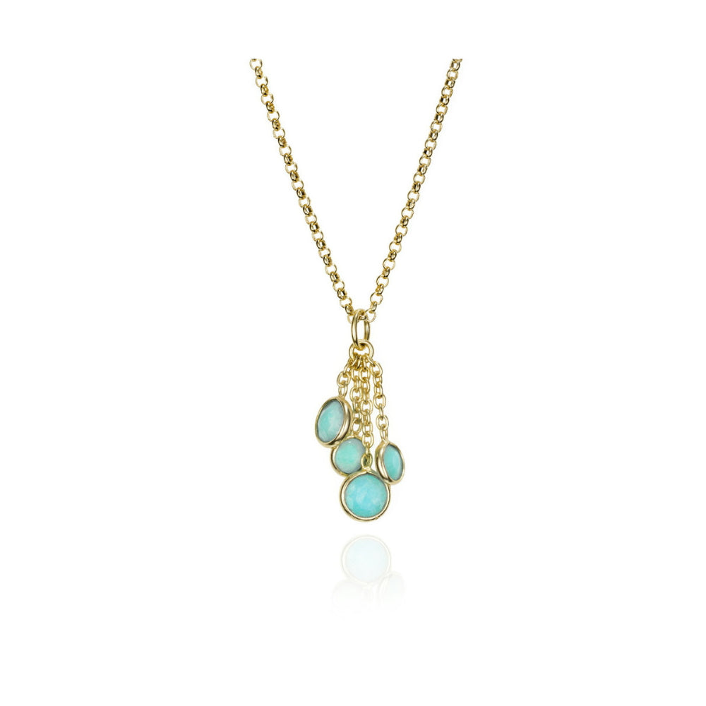 Gold necklace with turquoise pendant on a white background