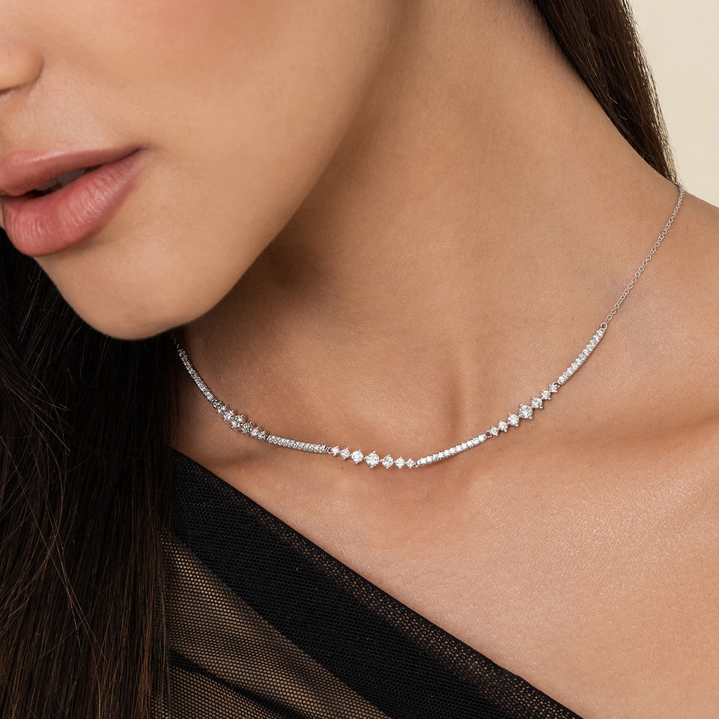 model wearing silver necklace with clear stones on natural background