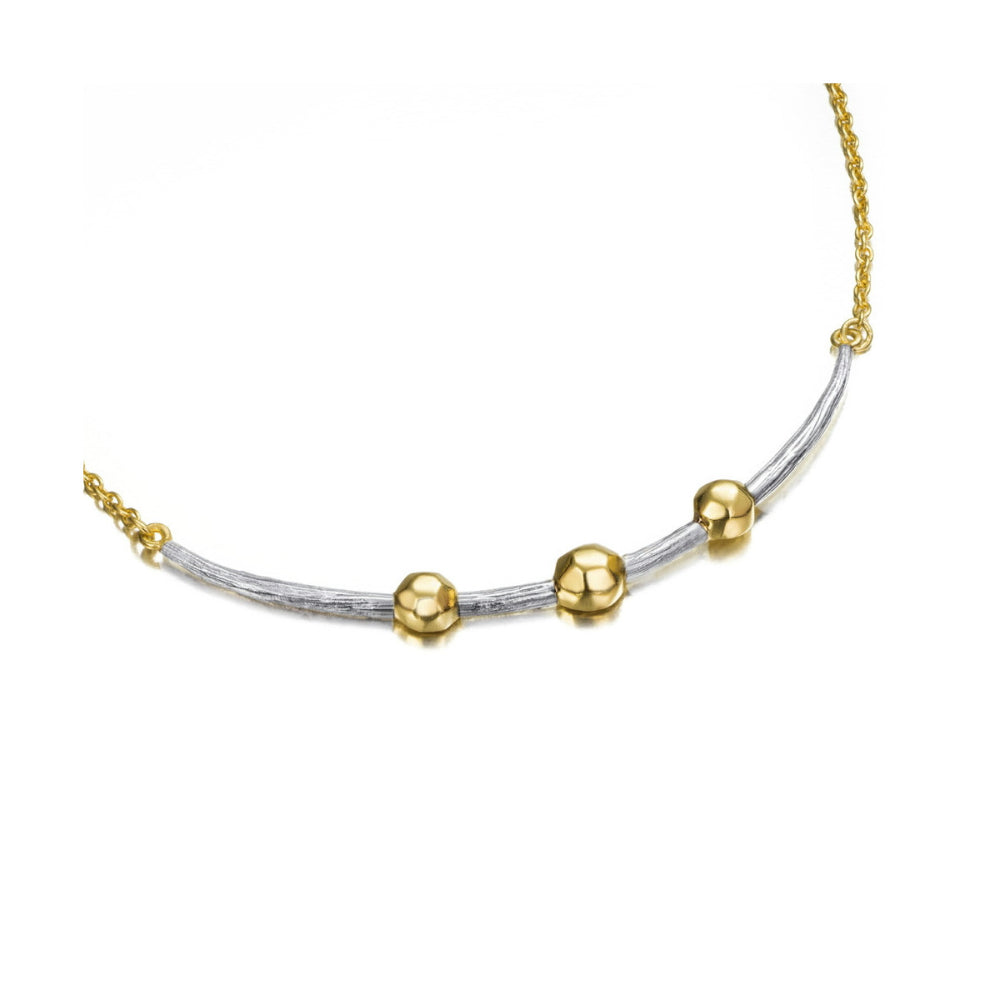 silver and gold necklace with beads on a white background