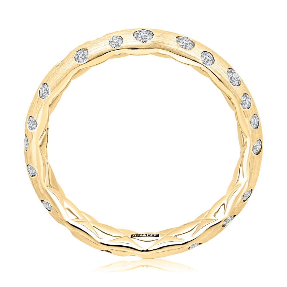 gold ring from the side with clear stones on a white background