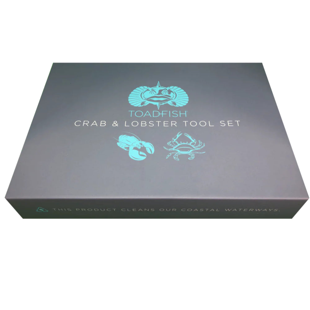 Set of crab cutters and seafood forks with teal handles in a grey box on a white background.