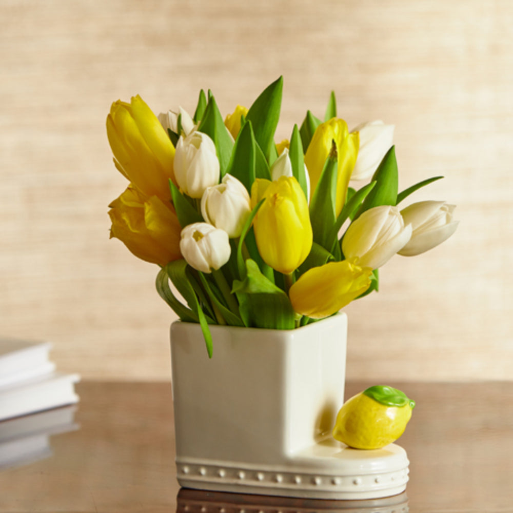 Yellow lemon mini attached to decor piece with flowers.