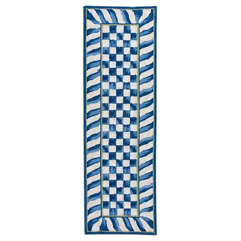 Rectangular royal blue and white checkered rug with wavy border on a white background