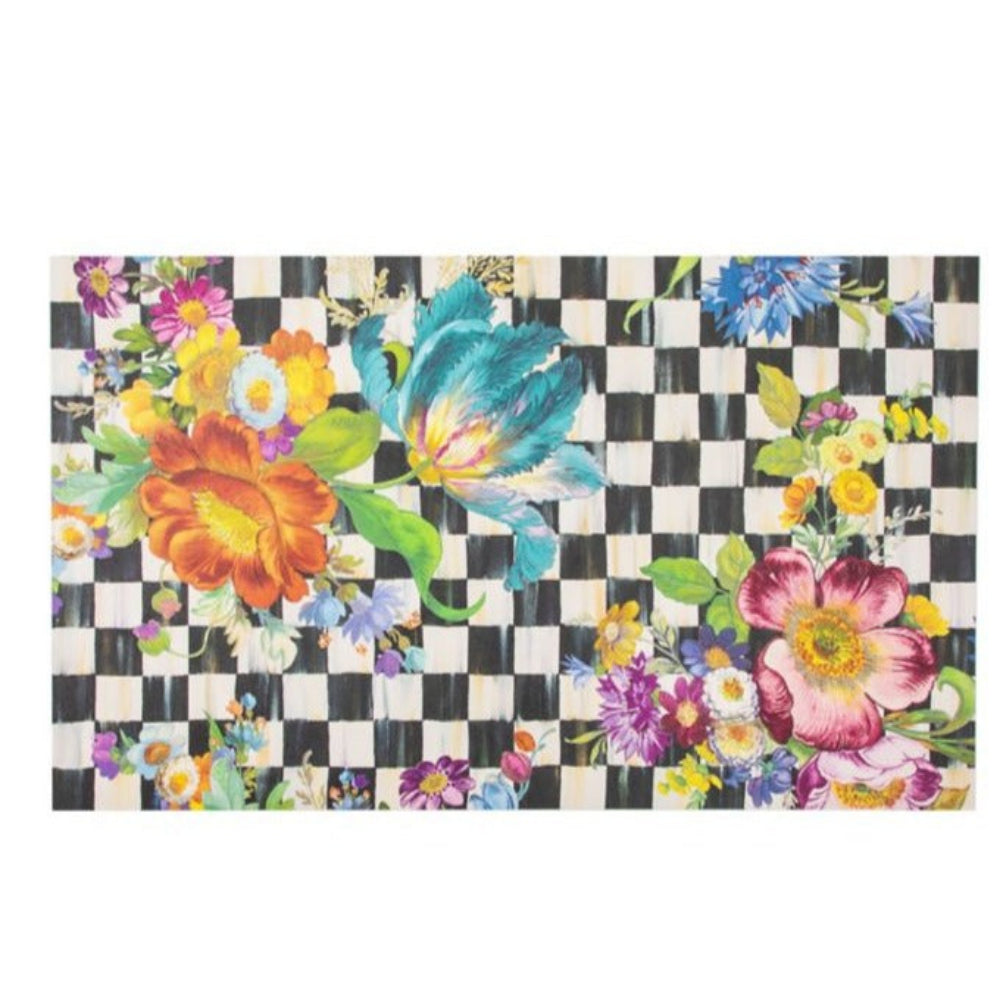 A medium size 3'x5' colorful floral design doormat on a black and white checkered background