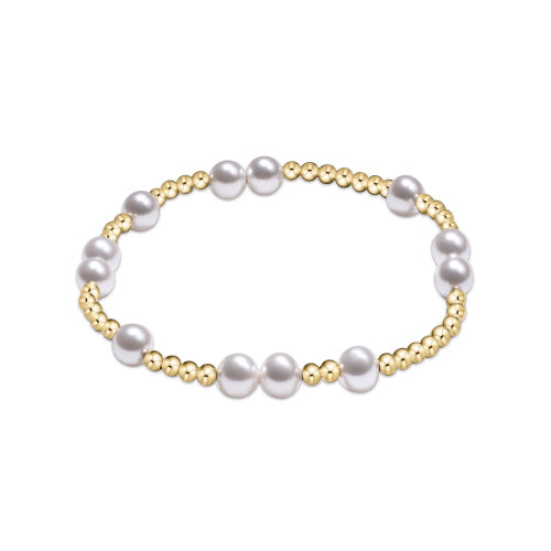 Pearl and gold beaded bracelet on a white background