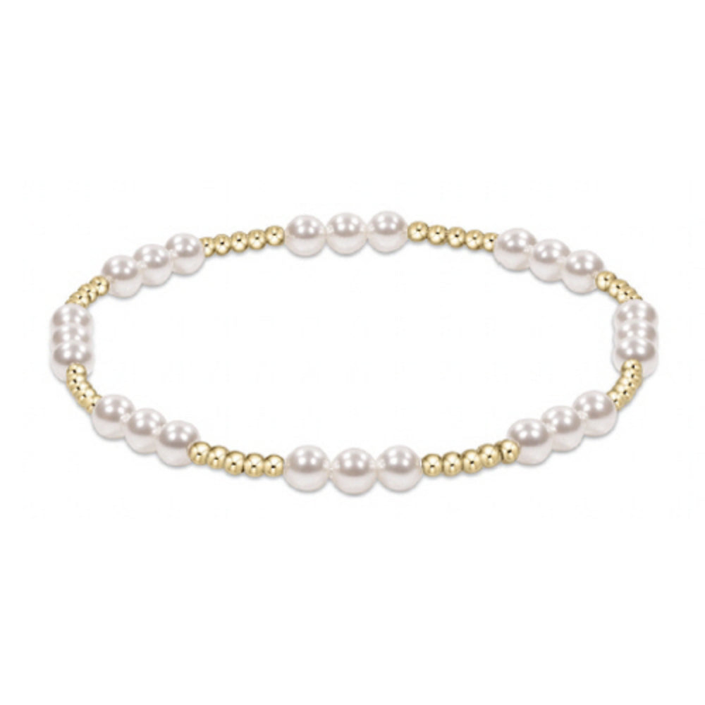 Pearl bracelet with gold beads on a white background