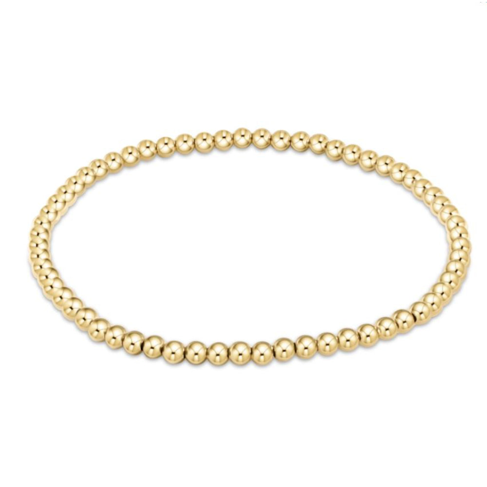Gold beaded bracelet on a white background