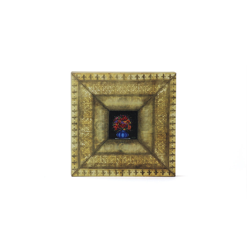 Decorative gold frame with a small vase and flowers inside on a white background.